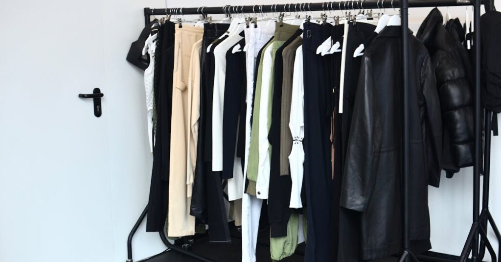 Stylish wardrobe with diverse clothing collection on a black rack in a bright room.